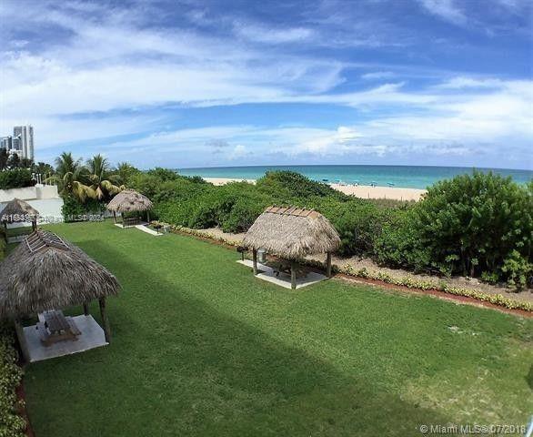 exterior space featuring a gazebo, a water view, and a view of the beach