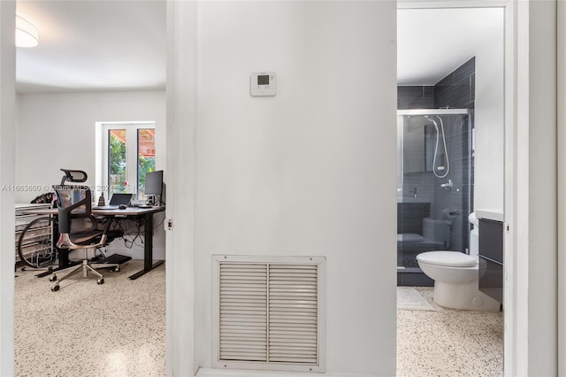 bathroom with walk in shower, vanity, and toilet