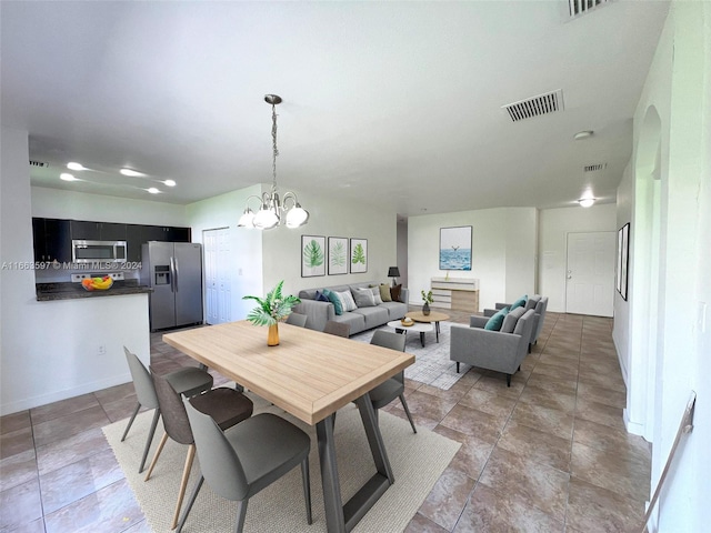 dining space with a notable chandelier