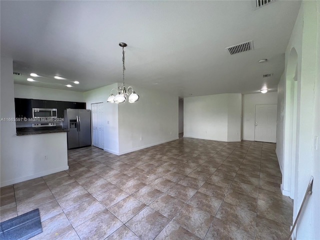 kitchen featuring pendant lighting, kitchen peninsula, stainless steel appliances, and an inviting chandelier