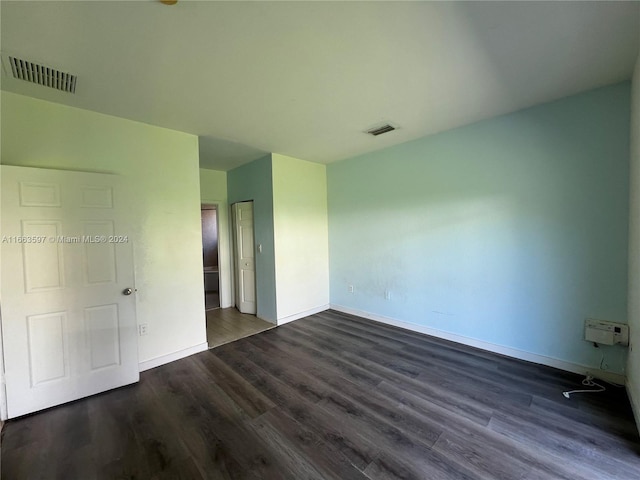 unfurnished bedroom featuring dark hardwood / wood-style flooring