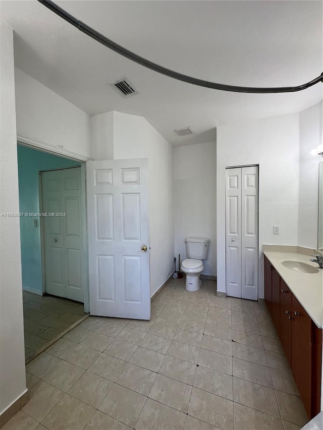 bathroom featuring tile patterned floors, vanity, and toilet