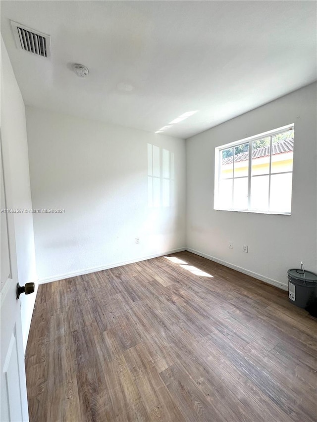 empty room with hardwood / wood-style floors