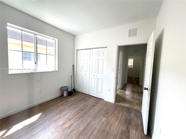 unfurnished bedroom featuring a closet and wood-type flooring