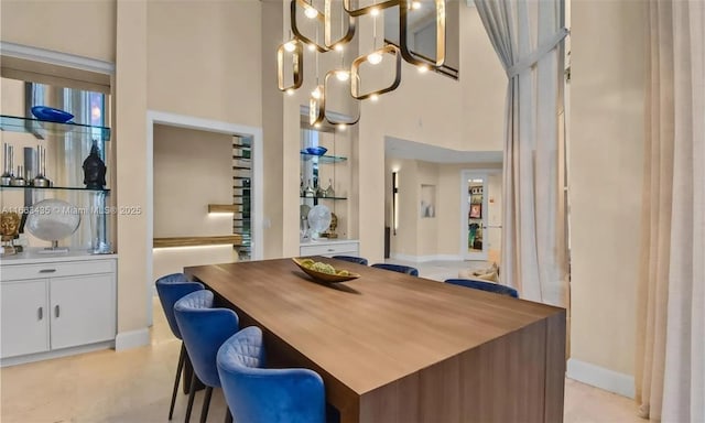 dining area featuring a high ceiling