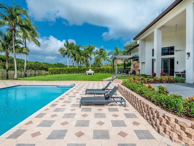 view of swimming pool with a patio area and a lawn