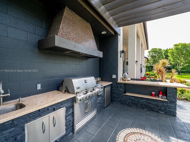 view of patio / terrace featuring area for grilling and sink