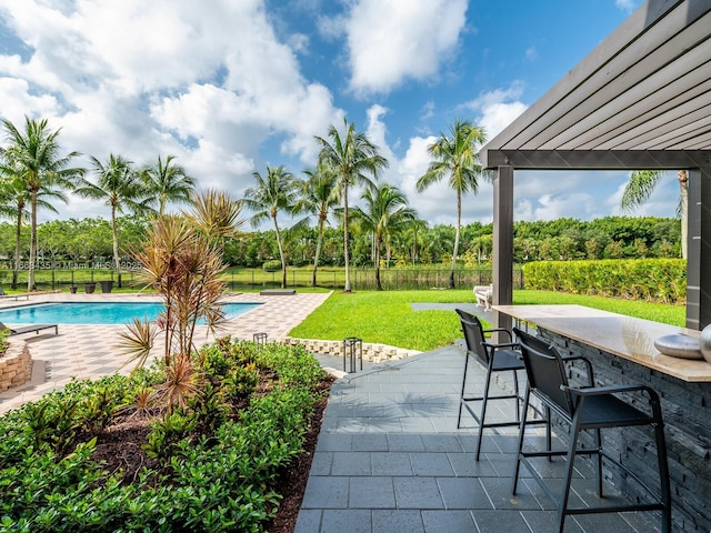 view of patio / terrace with a bar and a pergola