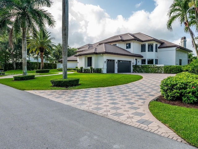 view of front of home featuring a garage and a front yard