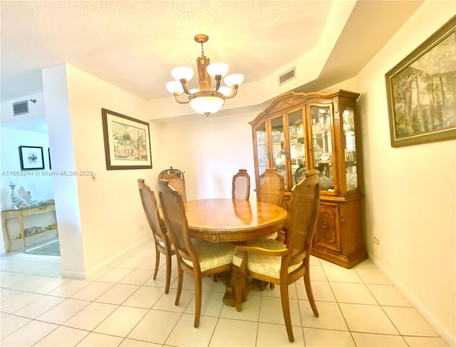 dining space with a chandelier and light tile patterned floors