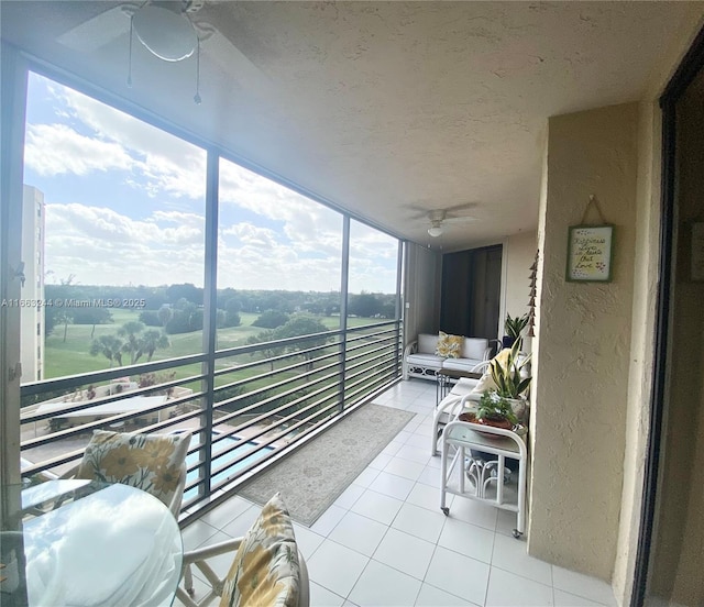 sunroom featuring ceiling fan