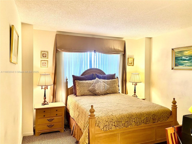 carpeted bedroom with a textured ceiling