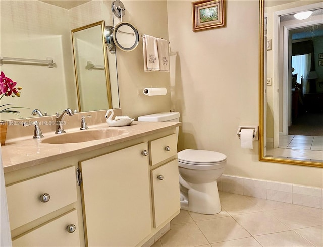 bathroom with vanity, tile patterned floors, and toilet