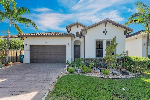 mediterranean / spanish home featuring a garage