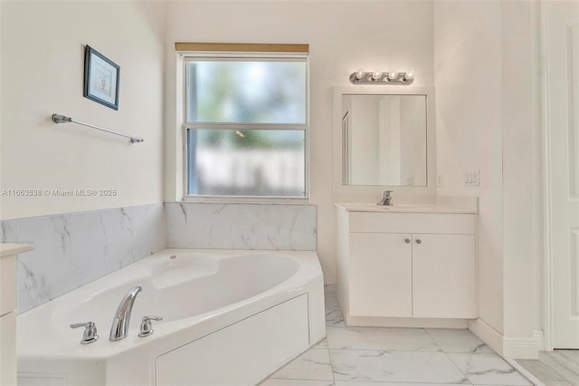 bathroom featuring vanity and a tub