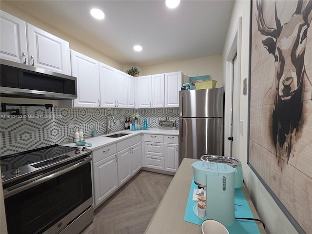 659 W Oakland Park Blvd Unit 218C, Oakland Park, FL 33311 - kitchen featuring appliances with stainless steel finishes, white cabinets, light countertops, backsplash, and recessed lighting