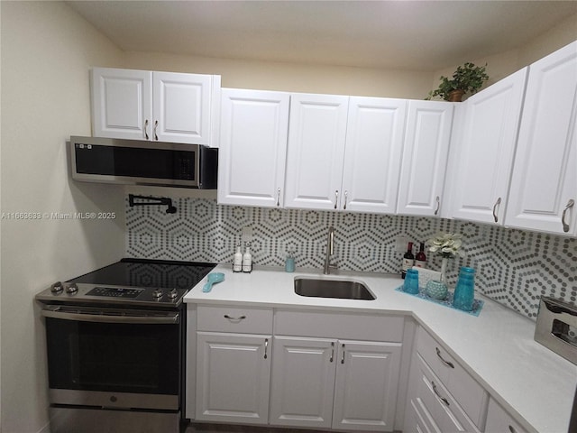 659 W Oakland Park Blvd Unit 218C, Oakland Park, FL 33311 - kitchen featuring stainless steel appliances, backsplash, white cabinetry, and light countertops