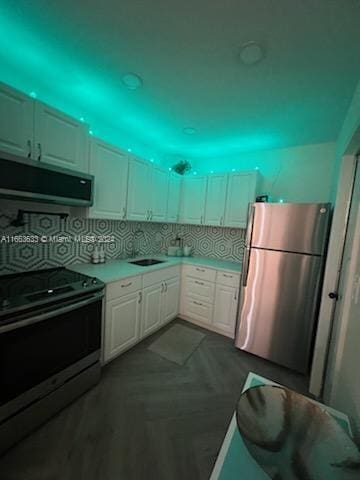 kitchen with decorative backsplash, stainless steel fridge, range with electric cooktop, exhaust hood, and white cabinetry