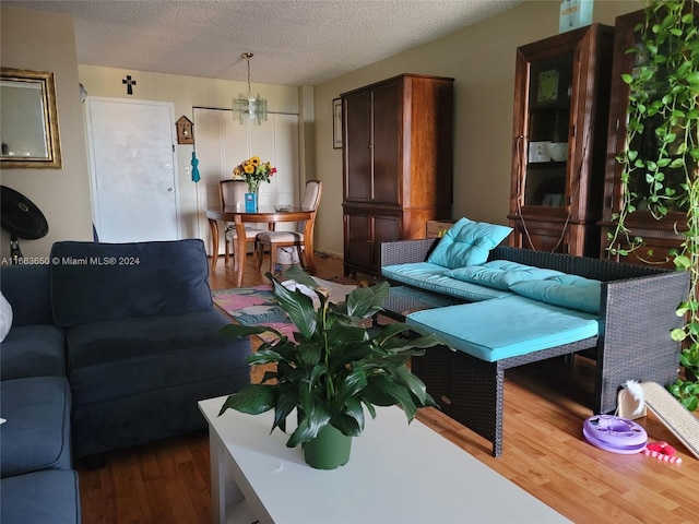 living room featuring dark wood-type flooring and a textured ceiling