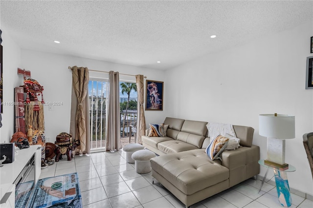 living room featuring light tile patterned flooring and a textured ceiling