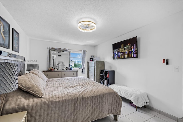 tiled bedroom featuring a textured ceiling