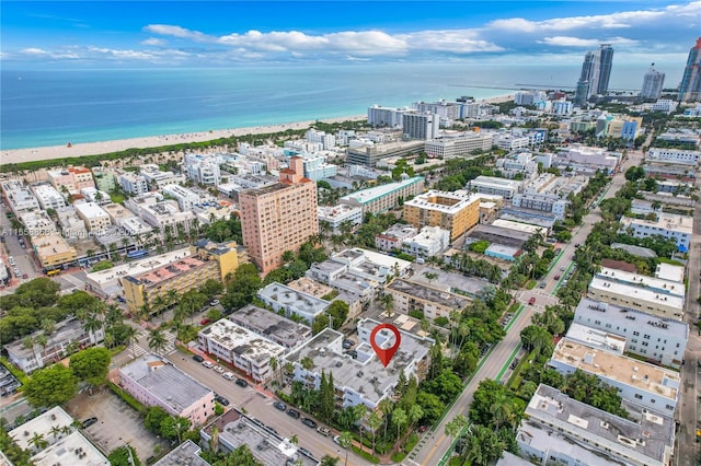 bird's eye view featuring a water view and a beach view