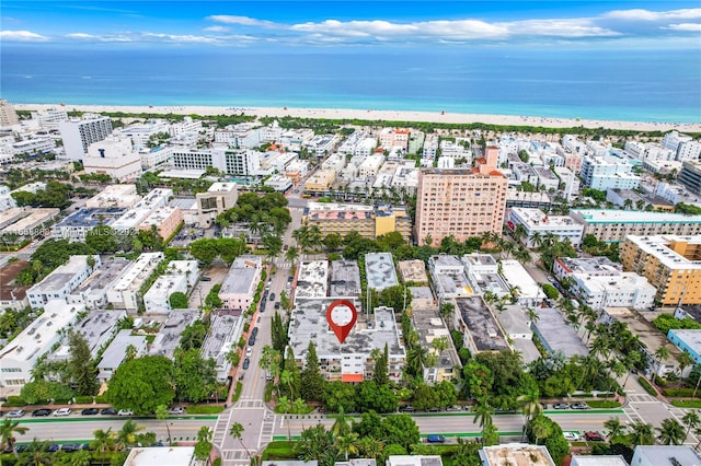 aerial view with a water view and a beach view