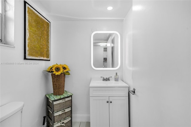 bathroom featuring vanity and toilet