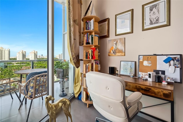 home office featuring a healthy amount of sunlight and concrete flooring