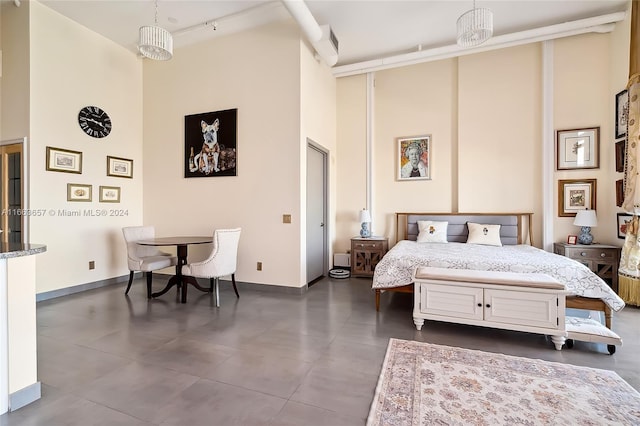 bedroom featuring a towering ceiling