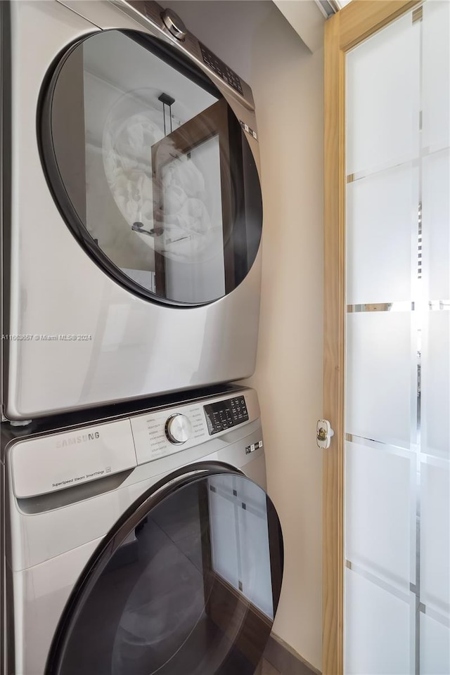 laundry area with stacked washer / drying machine