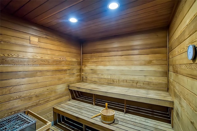 view of sauna / steam room featuring wood ceiling and wood walls