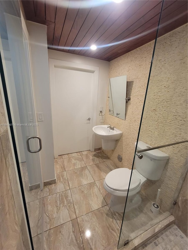 bathroom with wood ceiling, toilet, and sink