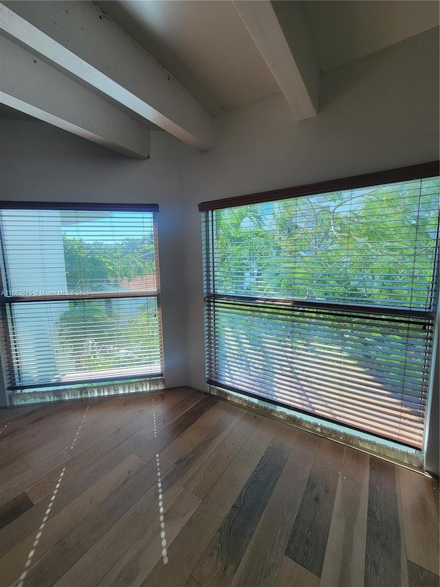 unfurnished room featuring beam ceiling and wood-type flooring