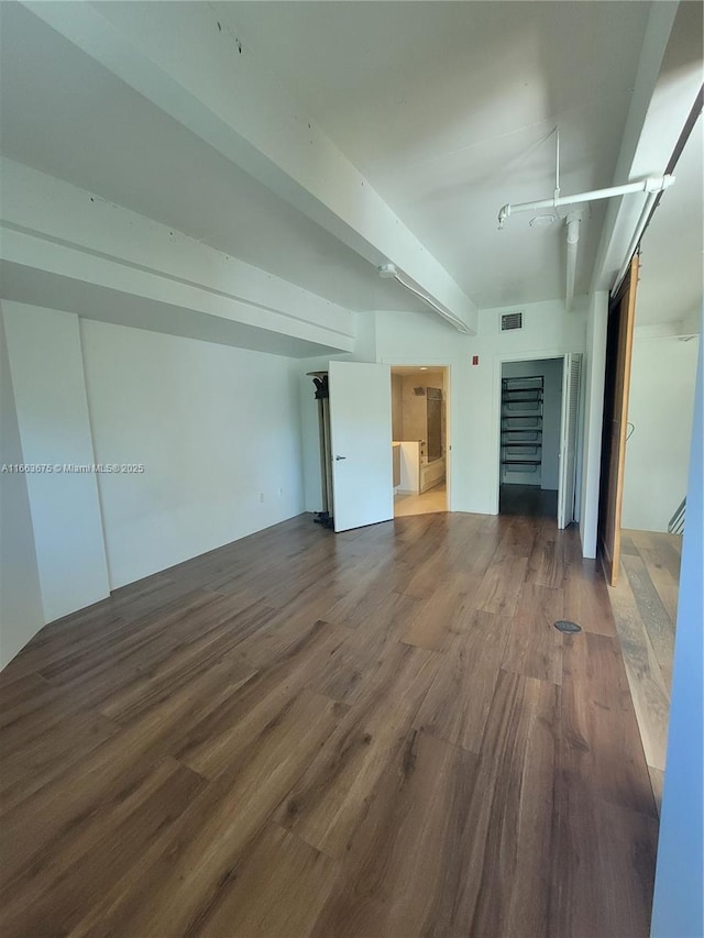 interior space featuring hardwood / wood-style floors and beam ceiling