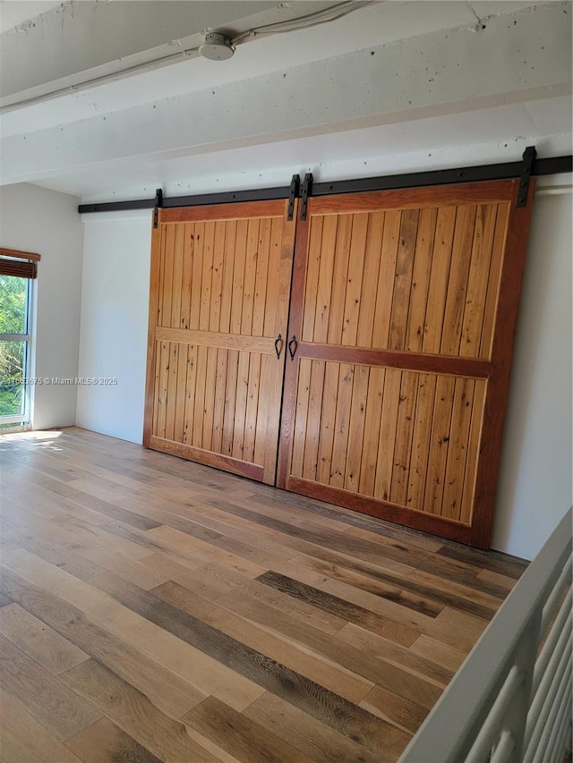 interior space with hardwood / wood-style flooring and a barn door