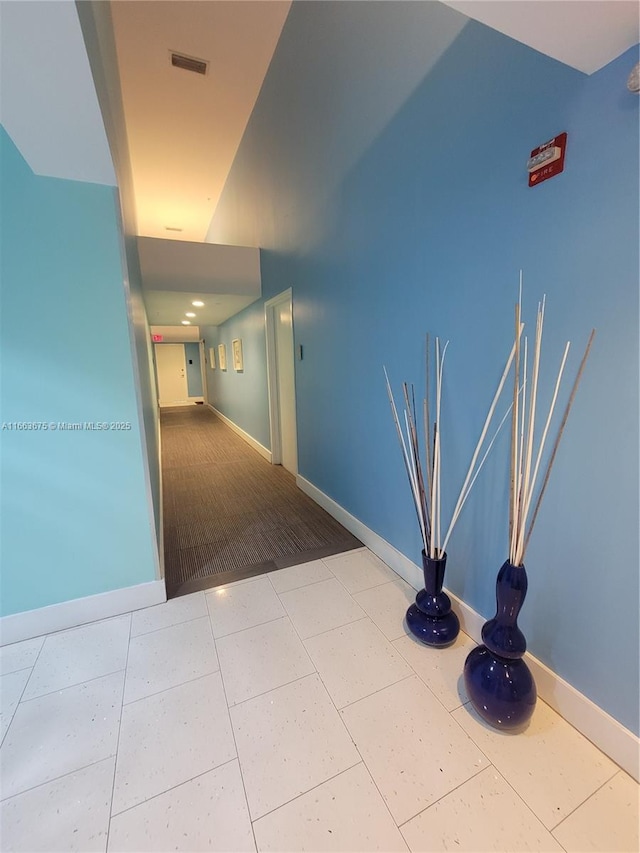 hallway with tile patterned flooring