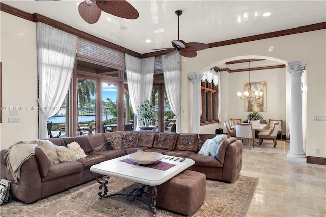 living room with ceiling fan with notable chandelier, decorative columns, and ornamental molding