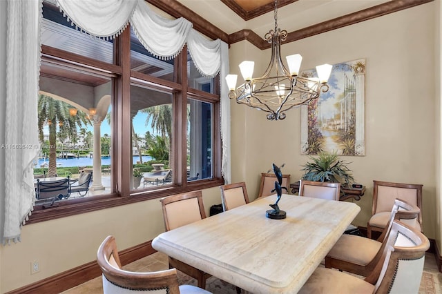 dining area featuring a water view, ornamental molding, and a chandelier