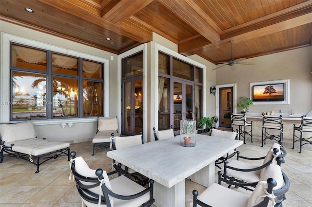 view of patio with ceiling fan and an outdoor bar