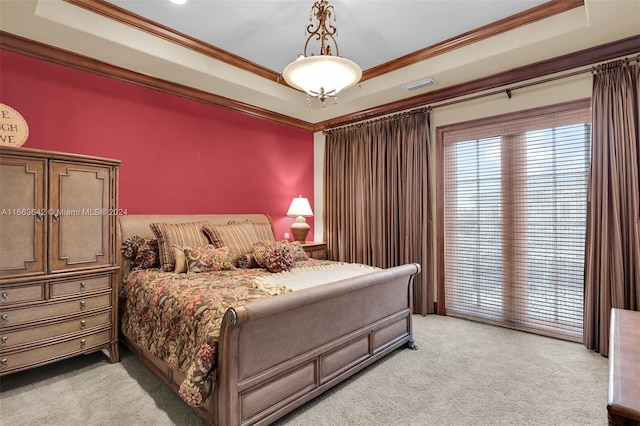 carpeted bedroom featuring ornamental molding and a raised ceiling