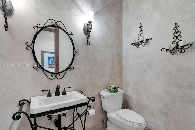 bathroom with sink and toilet