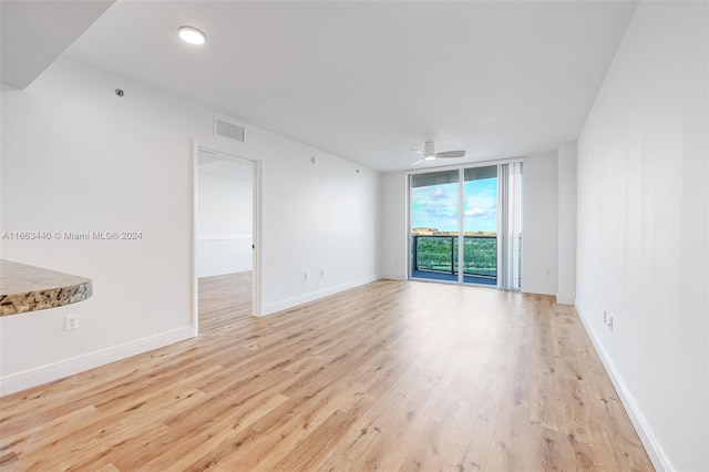 spare room with ceiling fan and light hardwood / wood-style flooring