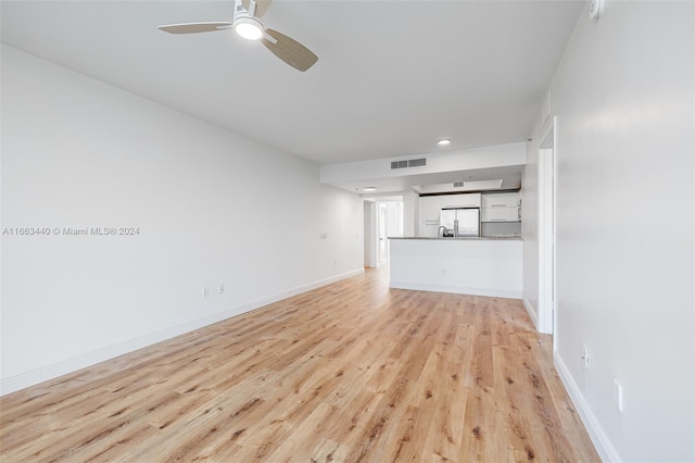 unfurnished living room featuring light hardwood / wood-style floors and ceiling fan