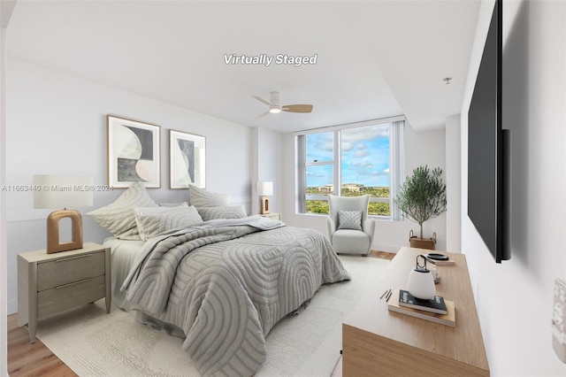 bedroom with ceiling fan and light hardwood / wood-style flooring