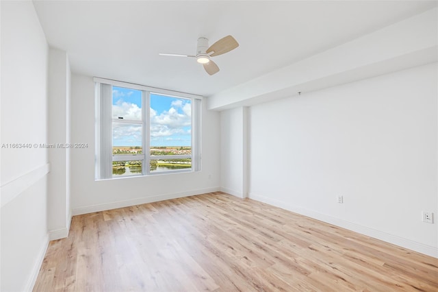 spare room featuring ceiling fan and light hardwood / wood-style floors