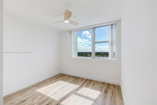 empty room with light wood-type flooring and ceiling fan