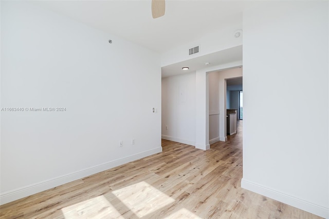 spare room with light wood-type flooring and ceiling fan