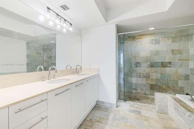 bathroom featuring vanity and separate shower and tub