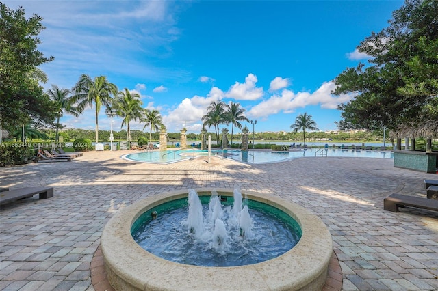 view of swimming pool featuring a water view